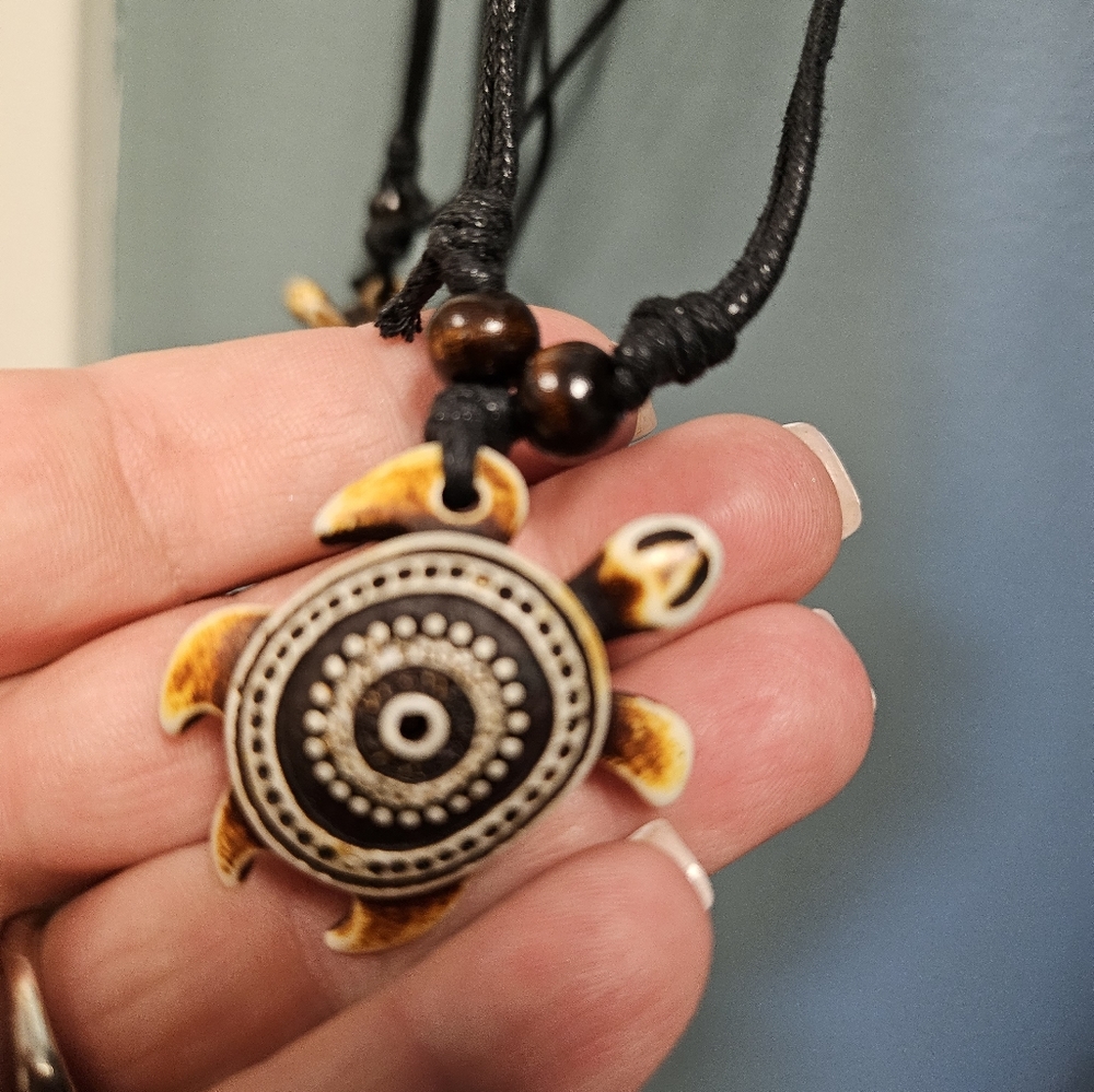 Turtle necklace on black cord necklace